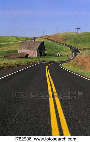 Stock Photograph - Barn beside a windy road. Fotosearch