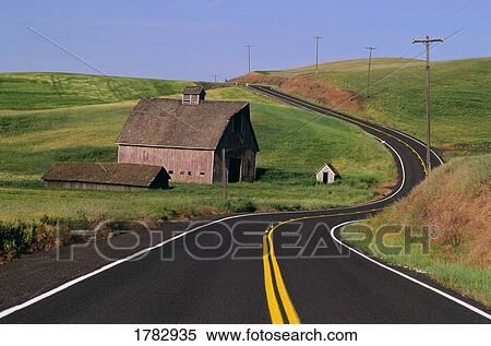 Stock Photography - Barn beside windy road. Fotosearch