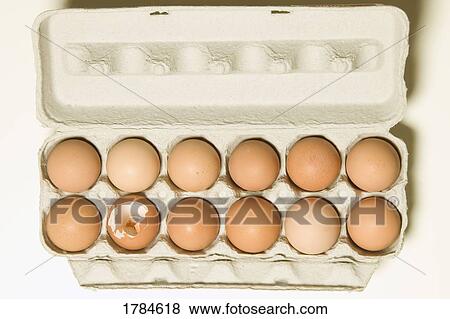 Broken egg in a dozen eggs View Large Photo Image Stock Photo - Broken egg in a dozen eggs. Fotosearch