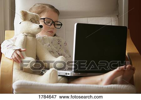Child and teddy bear hard at work View Large Photo Image Stock Photo - Child and teddy bear hard at work. Fotosearch