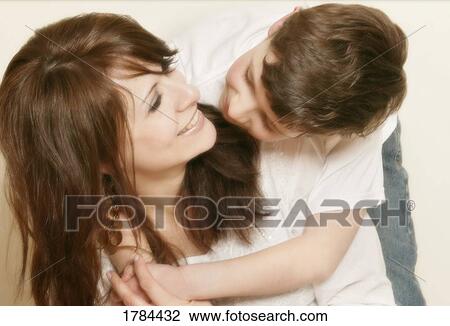Stock Image - Child embracing mother. Fotosearch