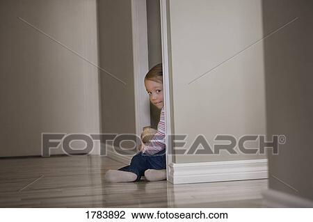 Stock Image - Child hides in a closet. Fotosearch
