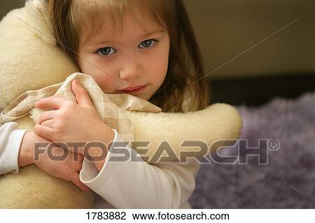 Child holds teddy bear View Large Photo Image Stock Image - Child holds teddy bear. Fotosearch