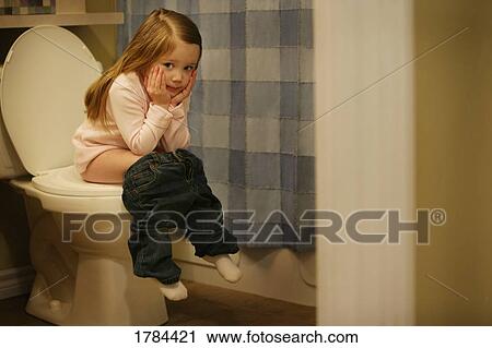 Stock Image - Child sits on the potty. Fotosearch