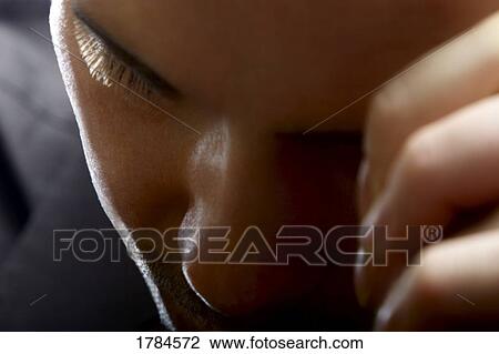 Stock Image - Close up of man praying. Fotosearch