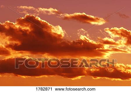 Stock Image - Clouds at sunset. Fotosearch
