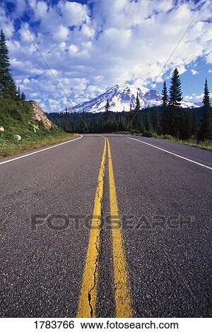 Stock Photograph - Double yellow line down middle of the road toward Mount Rainier. Fotosearch