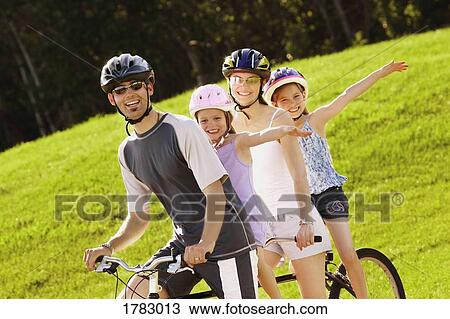 Family on a bicycle View Large Photo Image Stock Image - Family on a bicycle. Fotosearch