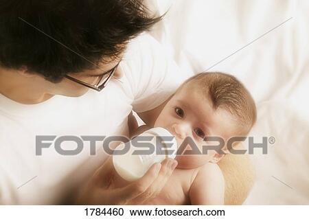 Stock Image - Father Feeding Son. Fotosearch