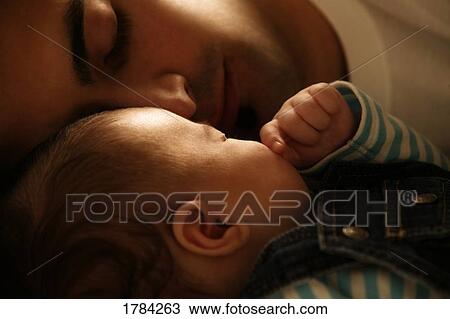 Stock Image - Father sleeping with baby. Fotosearch