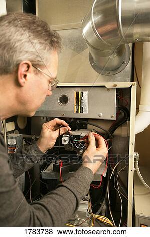 Stock Photo - Furnace repairman. Fotosearch