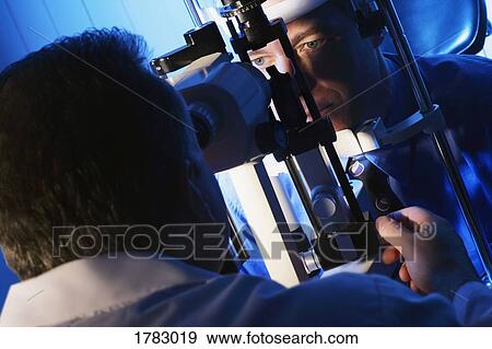 Stock Photo - Getting an eye exam. Fotosearch