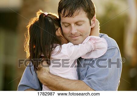 Stock Photo - Girl hugging father. Fotosearch