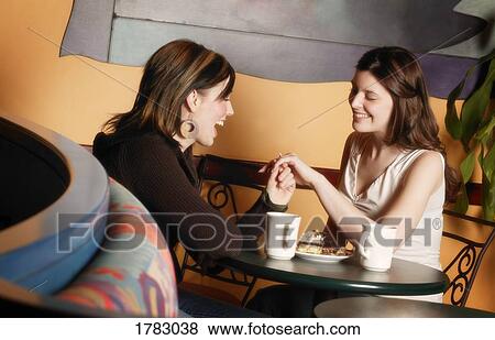 Stock Photo - Girlfriends talk about engagement. Fotosearch