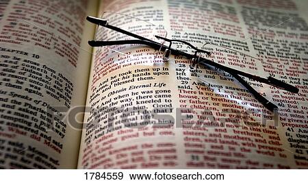 Stock Photo - Glasses on open Bible. Fotosearch