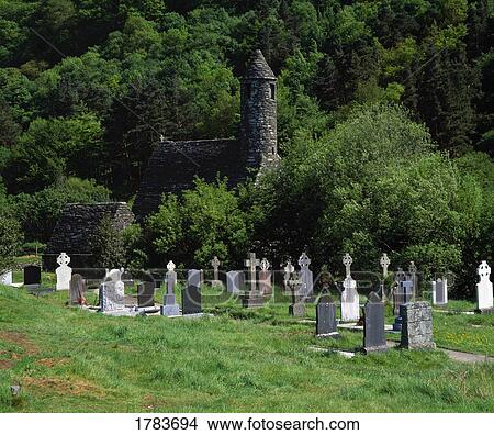 Gravestones and ruin of St. Kevin's Church, Glendalough Monastery View Large Photo Image Picture - Gravestones and ruin of St. Kevin's Church, Glendalough Monastery. Fotosearch