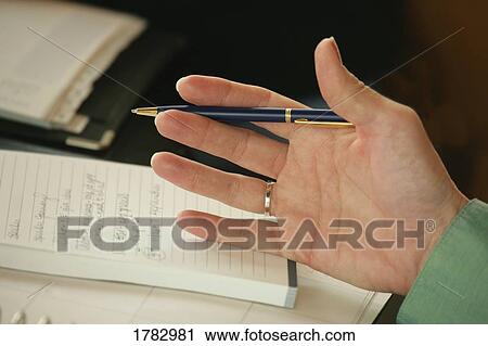 Stock Image - Hand holding a pen. Fotosearch