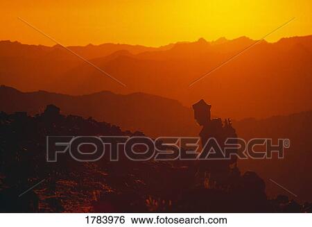 Stock Photograph - Hiker silhouette, sunset, Wallowas Eaglecap Wilderness. Fotosearch