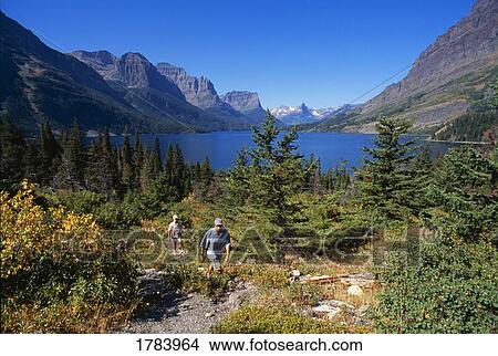 Hikers, Saint Mary Lake, Glacier National Park View Large Photo Image Picture - Hikers, Saint Mary Lake, Glacier National Park. Fotosearch