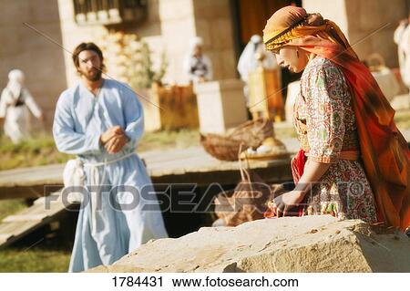 Stock Image - Jesus approaching a woman. Fotosearch