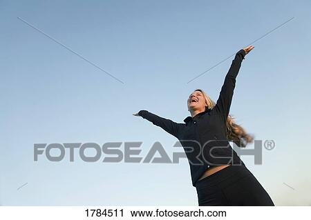 Stock Image - Lifting hands to the sky. Fotosearch