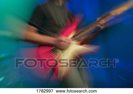 Stock Photo - Man playing electric guitar. Fotosearch