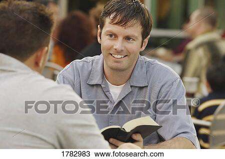 Man sharing from a book View Large Photo Image Stock Image - Man sharing from a book. Fotosearch