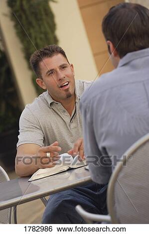 Stock Photograph - Men having a discussion. Fotosearch