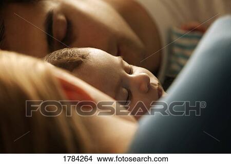 Picture - Mom, Dad and baby sleeping. Fotosearch