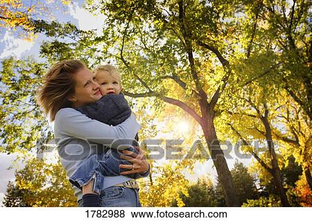 Stock Photo - Mother embracing child. Fotosearch