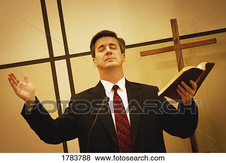 Stock Photo - Pastor praying. Fotosearch