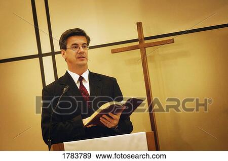 Pastor preaching from pulpit View Large Photo Image Stock Photo - Pastor preaching from pulpit. Fotosearch