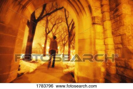 Person strolling through arches View Large Photo Image Stock Photograph - Person strolling through arches. Fotosearch