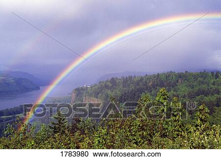 Stock Image - Rainbow over Columbia River Gorge. Fotosearch