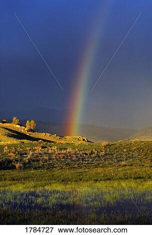 Rainbow over hills View Large Photo Image Stock Photo - Rainbow over hills. Fotosearch