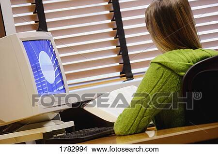 Picture - Reading the Bible at the office. Fotosearch