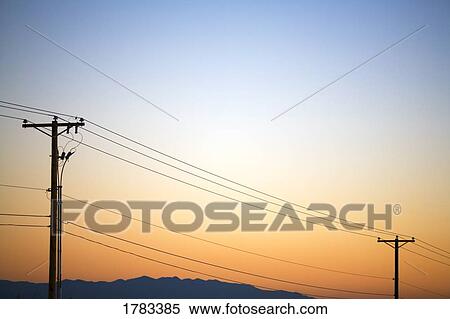 Stock Photography - Silhouette of power lines at sunset. Fotosearch