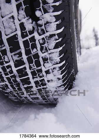 Picture - Snow on tire. Fotosearch