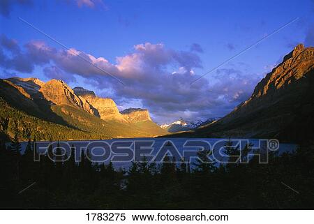 Stock Photography - Summer sunrise at Saint Mary Lake, Wild Goose Island, Glacier National Park. Fotosearch