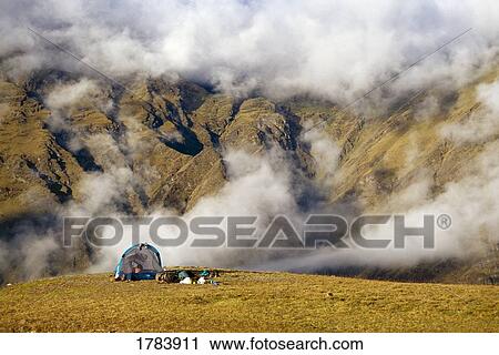 Stock Image - Tent camping in clouds, Andes Mountains, South America. Fotosearch