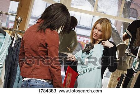 Two women shopping together View Large Photo Image Stock Image - Two women shopping together. Fotosearch