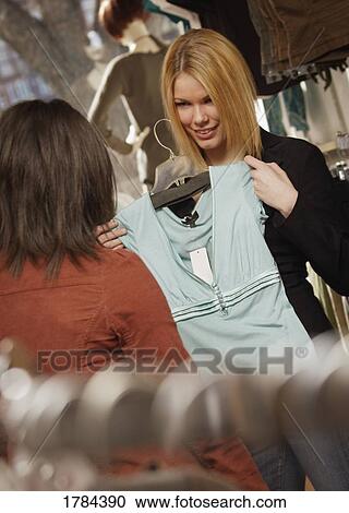Stock Image - Two young adults shopping. Fotosearch