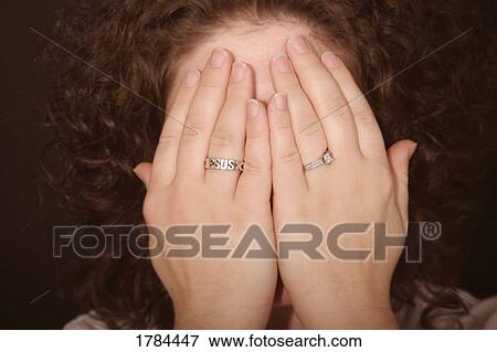 Woman covering her face View Large Photo Image Stock Photo - Woman covering her face. Fotosearch