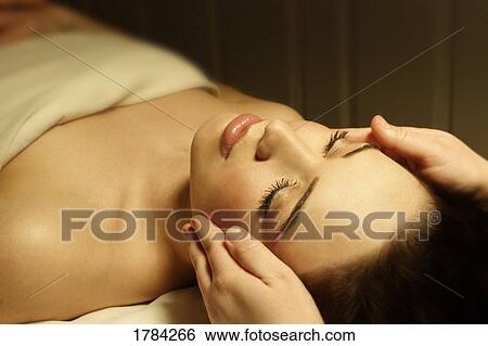 Stock Photograph - Woman having a facial massage. Fotosearch