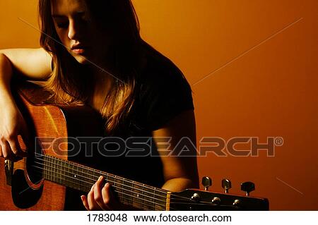 Stock Photo - Woman playing guitar. Fotosearch