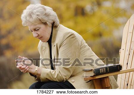 Woman praying View Large Photo Image Stock Photo - Woman praying. Fotosearch