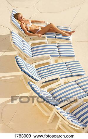 Woman suntanning View Large Photo Image Stock Photo - Woman suntanning. Fotosearch
