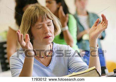 Stock Image - Woman with her hands raised. Fotosearch