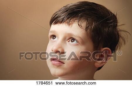 Stock Image - Young boy looking off. Fotosearch