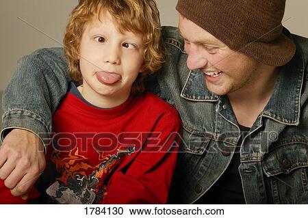 Stock Image - Young boy with young adult goofing around. Fotosearch